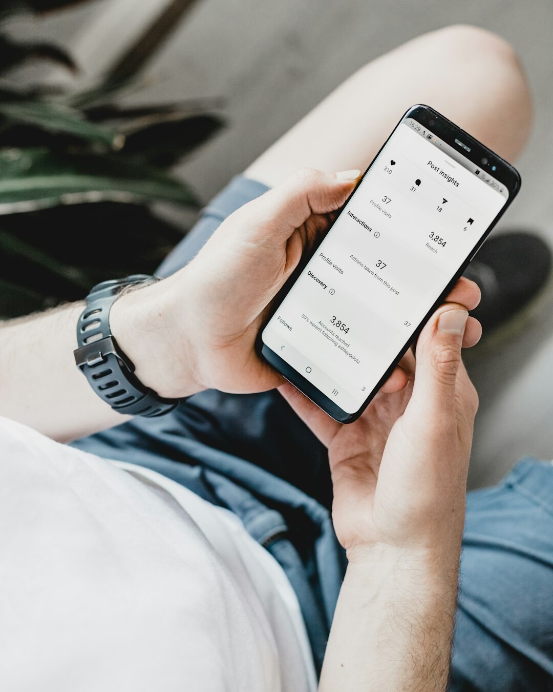 person scrolling on smartphone