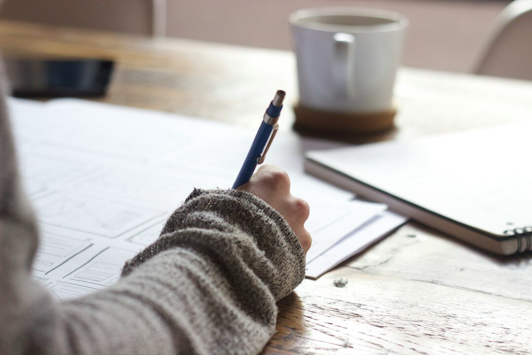 person journaling about media habits